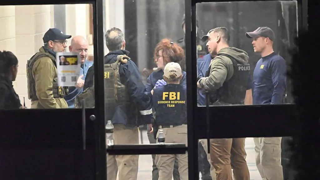 FBI officers work at the scene in Providence, Rhode Island, on Saturday night after the Brown University shooting.