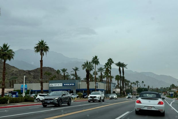 Drivers navigate heavy rain on East Palm Canyon Drive in Palm Springs, California, Dec. 23, 2025.
