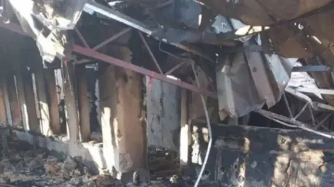 Heavily damaged building with a collapsed roof in Khorly, Kherson region, shown in images released by Russian-installed authorities.