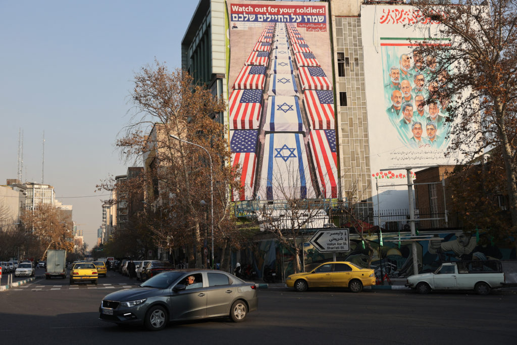 A car passes an anti-U.S. and anti-Israeli billboard in Tehran on Jan. 4, 2026.