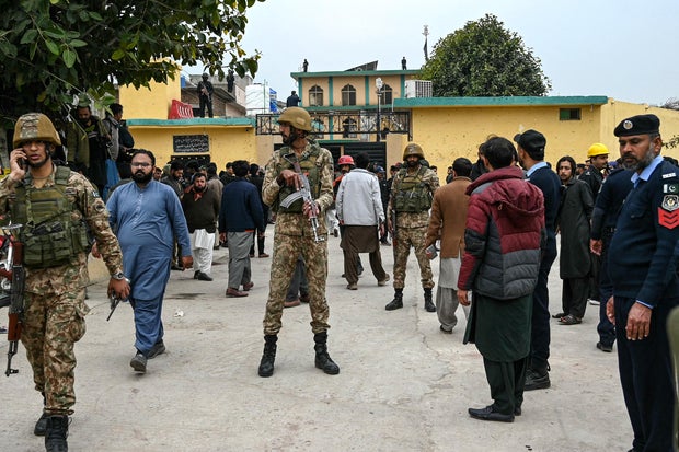 Security personnel stand guard outside a mosque following an explosion in Islamabad, Pakistan, Feb. 6, 2026.