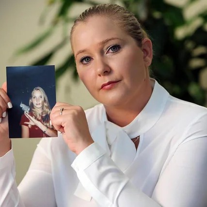 Virginia Giuffre with a photo of herself as a teen - Emily Michot/Miami Herald/Tribune News Service via Getty Images