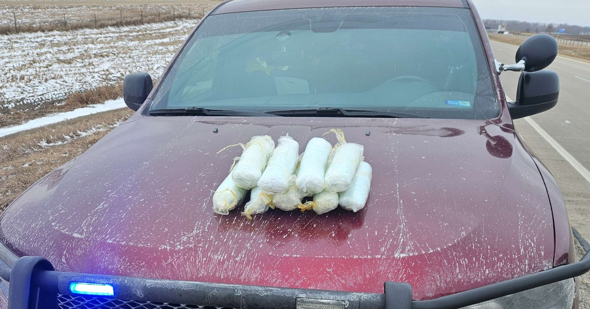 Seized drug packages on a vehicle hood during a law enforcement operation (file photo), illustrating cartel trafficking routes.