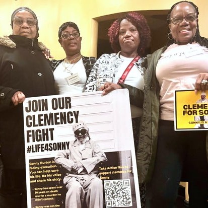 Eddie Mae Ellison, Jackie Bradford, Mary Bradford and Lois Harris hold signs urging Alabama Gov. Kay Ivey to grant clemency for their family member Charles "Sonny" Burton, Jan. 28, 2026 in Montgomery, Ala. - cbs