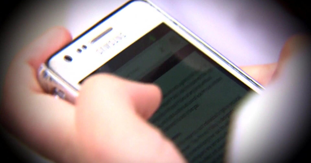 Close-up of hands using a smartphone, representing dating apps and swiping fatigue.