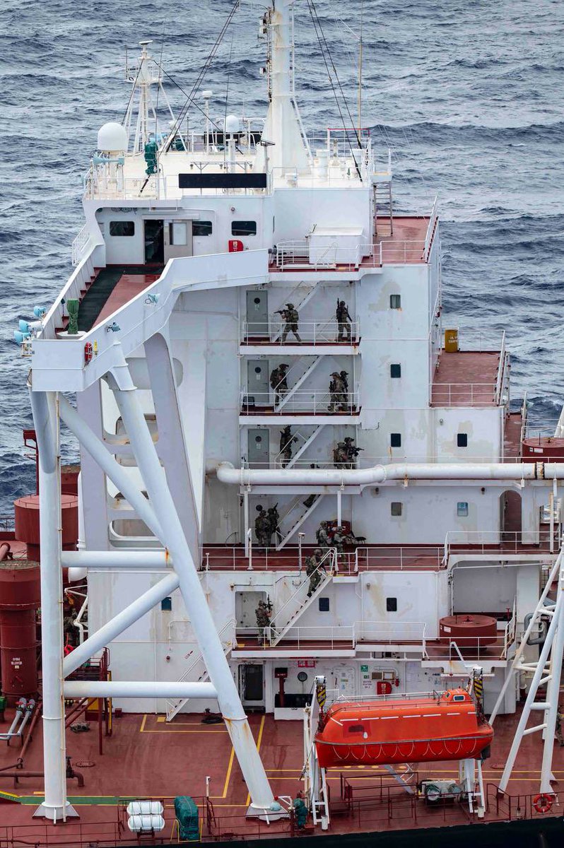 Veronica III superstructure with U.S. boarding teams on exterior stairways during the interdiction.