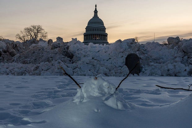 Snow piled near the U.S. Capitol Reflecting Pool as crews clear Washington, D.C., Jan. 31, 2026.
