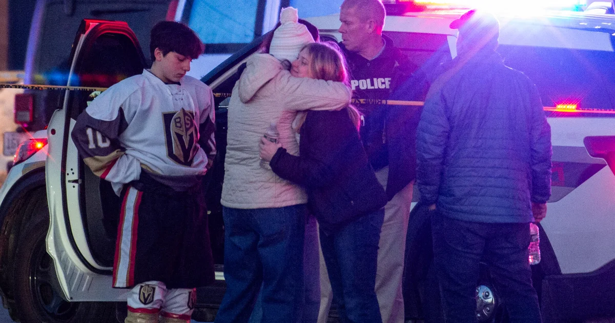 People embrace near Lynch Arena after the shooting