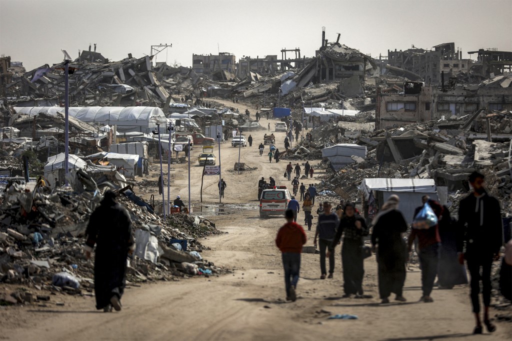 Devastated street and collapsed buildings in Gaza, illustrating the scale of reconstruction needed.