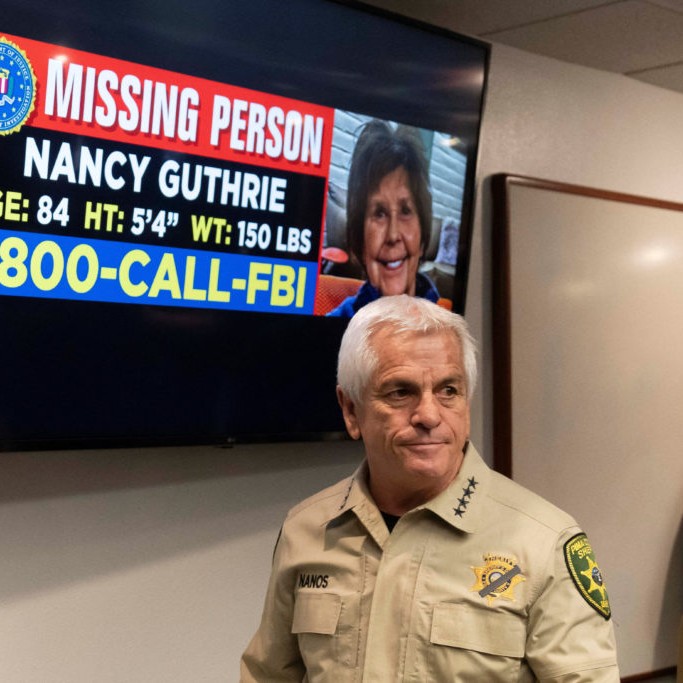 Left: Pima County Sheriff Chris Nanos exits the press room past a missing persons poster after giving an update on the investigation after the disappearance of Nancy Guthrie, the 84-year-old mother of U.S. journalist and television host Savannah Guthrie, who went missing from her home in Tucson, Arizona. Photo by Rebecca Noble/ Reuters - pbs