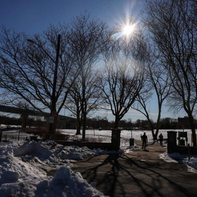 Left: People walk during cold weather at Powell's Cove Park in the Queens borough of New York City, U.S., February 13, 2026. REUTERS/Shannon Stapleton - pbs