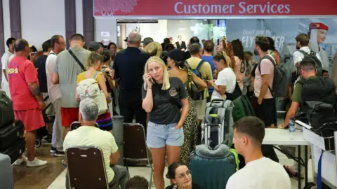 Stranded passengers at Bali's Ngurah Rai International Airport after Emirates suspended Dubai operations