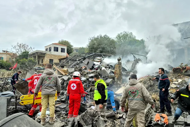First aid responders at the site of an Israeli airstrike in Kfar Roummane, southern Lebanon, March 26, 2026. Abbas Fakih/AFP/Getty.