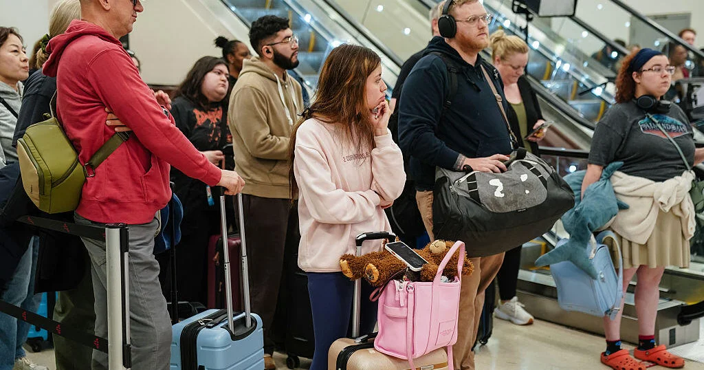 Travelers wait in a long TSA security line at a U.S. airport during staffing shortages