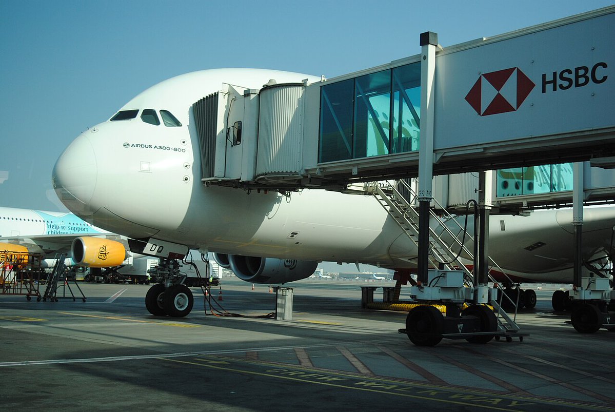 Aircraft at a jet bridge as operations pause at Gulf hubs during regional airspace closures