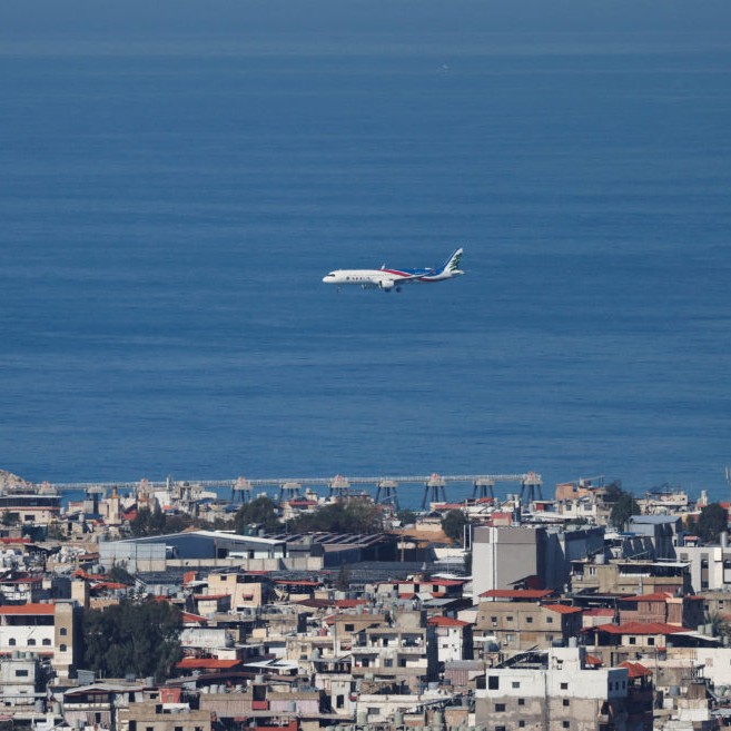 Left: A Lebanese Middle East Airlines (MEA) aircraft flies over Beirut following an escalation between Hezbollah and Israel amid the U.S.-Israel conflict with Iran, Lebanon, March 2, 2026. Photo by Mohamed Azakir/Reuters - Photo by Mohamed Azakir/Reuters