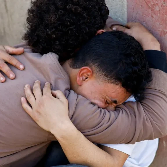 Relatives of those killed during the clashes mourned outside al-Aqsa hospital in Deir al-Balah - Reuters