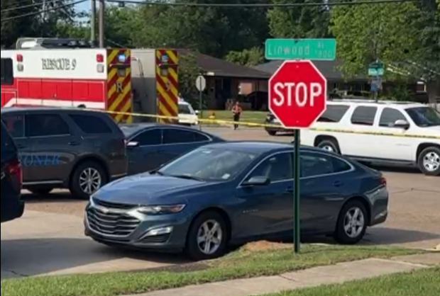 Shreveport police vehicles block an intersection during the response to multiple domestic-related shootings.