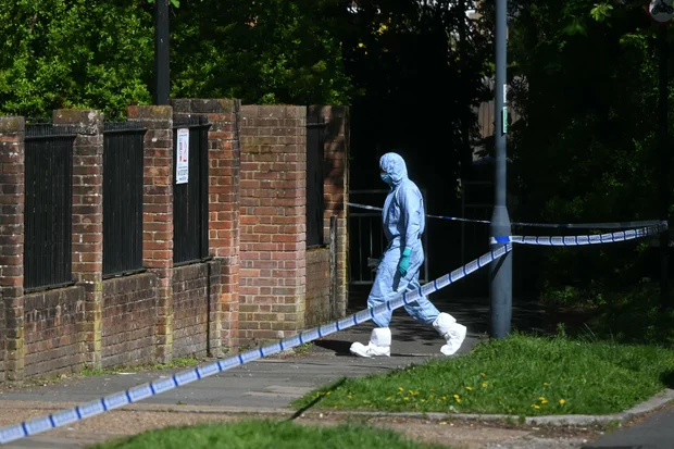 Police forensic officer works inside a cordon at Kenton United Synagogue in London, April 19, 2026.