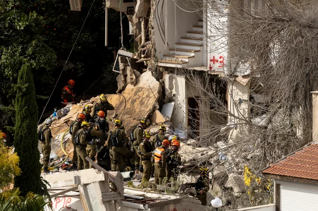 Israeli emergency responders at a residential building after an apparent Iranian ballistic missile strike on April 6, 2026, in Haifa, Israel. (Amir Levy/Getty)