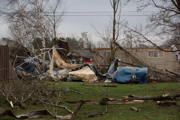 Debris and fallen tree limbs cover the ground after a severe storm that tore through the Upper Midwest on Friday, April 17, 2026, in Rochester, Minn. - Hollie Bennett Piotrowicz / AP