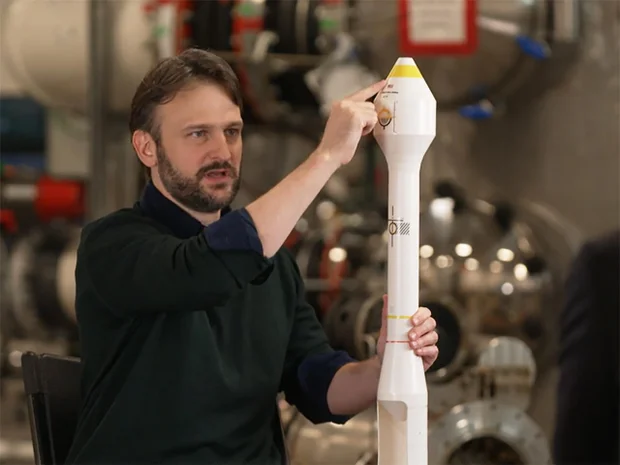 Panthalassa CEO Garth Sheldon-Coulson with a model of the untethered Ocean-3 wave-powered platform.