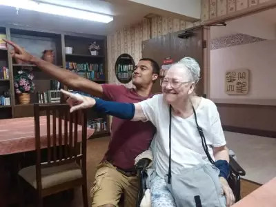 Pearlene Darby with her grandson Caleb Darby in a family photo, smiling and dancing