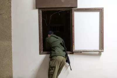 Volunteers in Tehran sew Iranian flags for free distribution during heightened tensions.