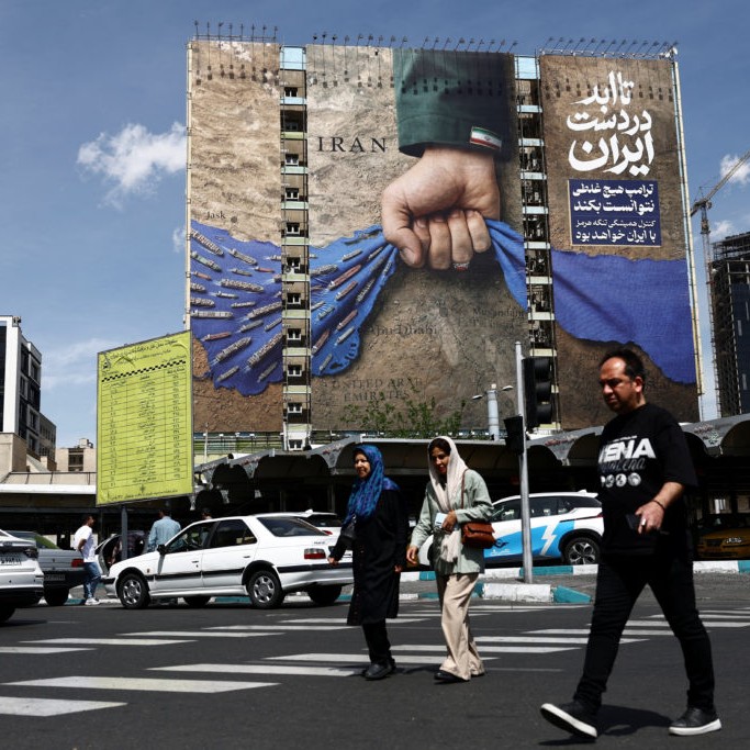 Left: People walk past a billboard with a graphic design about the Strait of Hormuz on a building, amid a ceasefire between U.S. and Iran, in Tehran, Iran, April 27, 2026. Majid Asgaripour/WANA (West Asia News Agency) via Reuters - Majid Asgaripour/WANA (West Asia News Agency) via Reuters