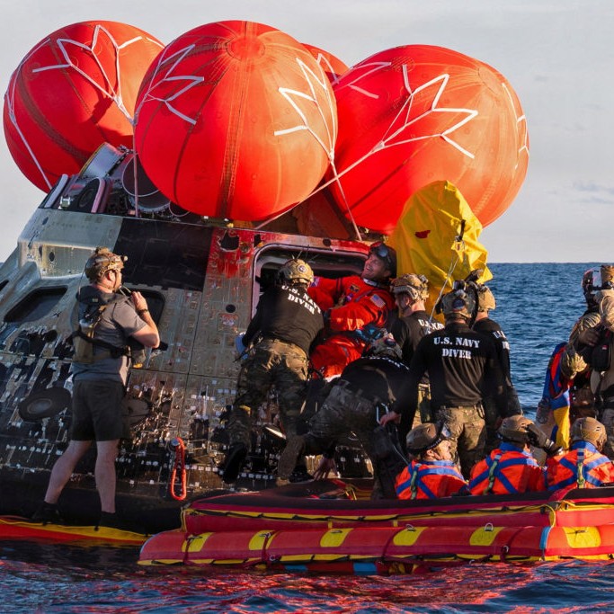 NASA Astronaut Reid Wiseman, Artemis II mission commander, exits the Orion crew module to join the three other crew in a raft - U.S. Navy/Mass Communication Specialist David Rowe/Handout via Reuters