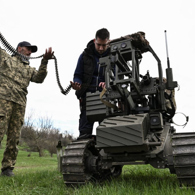 Left: Ukrainian servicemen load ammunition into an unmanned ground vehicle before testing it at a training ground near a front line, amid Russia's attack on Ukraine, in Zaporizhzhia region, Ukraine April 10, 2026. Photo by Stringer/Reuters - Stringer/Reuters